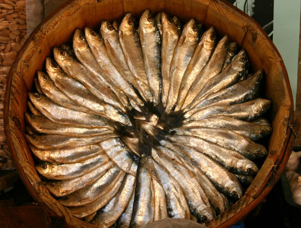 Multiple Xouba fishes sitting on a plate, ready to be cooked