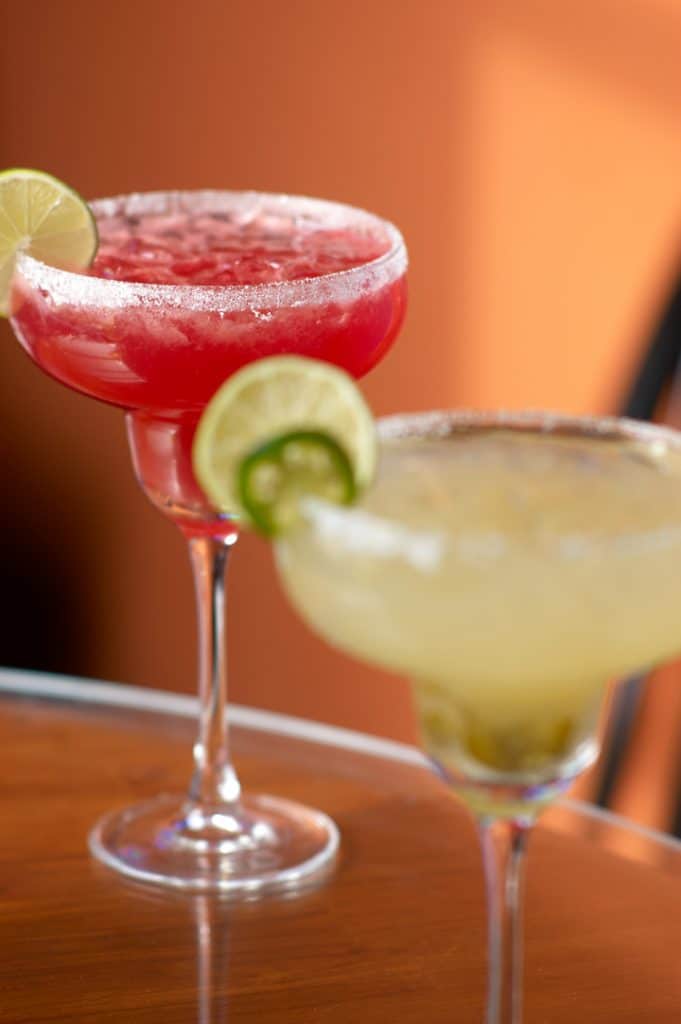 A cocktail glass filled with grapefruit Daiquiri, glancing red like blood