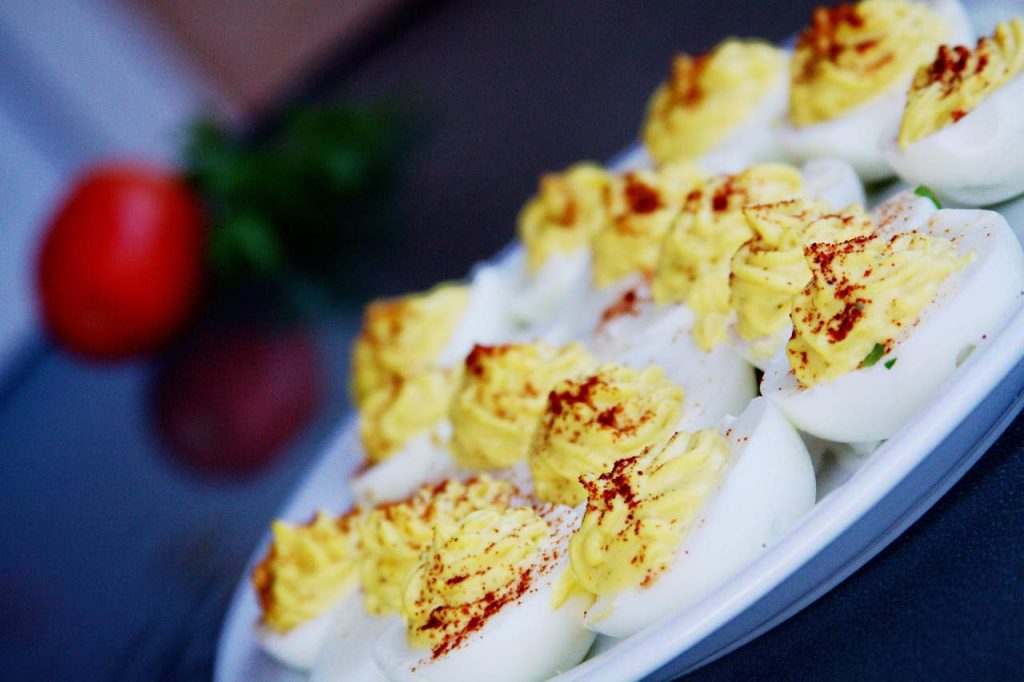 Deviled Eggs with sprinkled hot pepper flakes above them