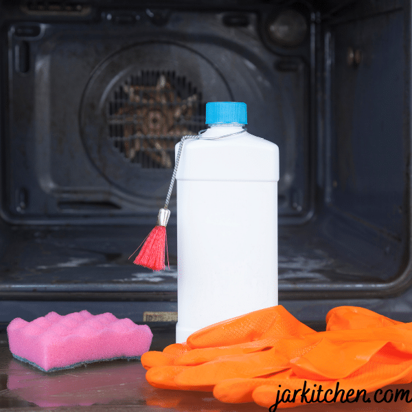 Oven cleaner standing in front of an oven, ready for cleaning